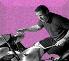 fusica speckled and embossed bacground with black and white image of drummer Matt Kelly